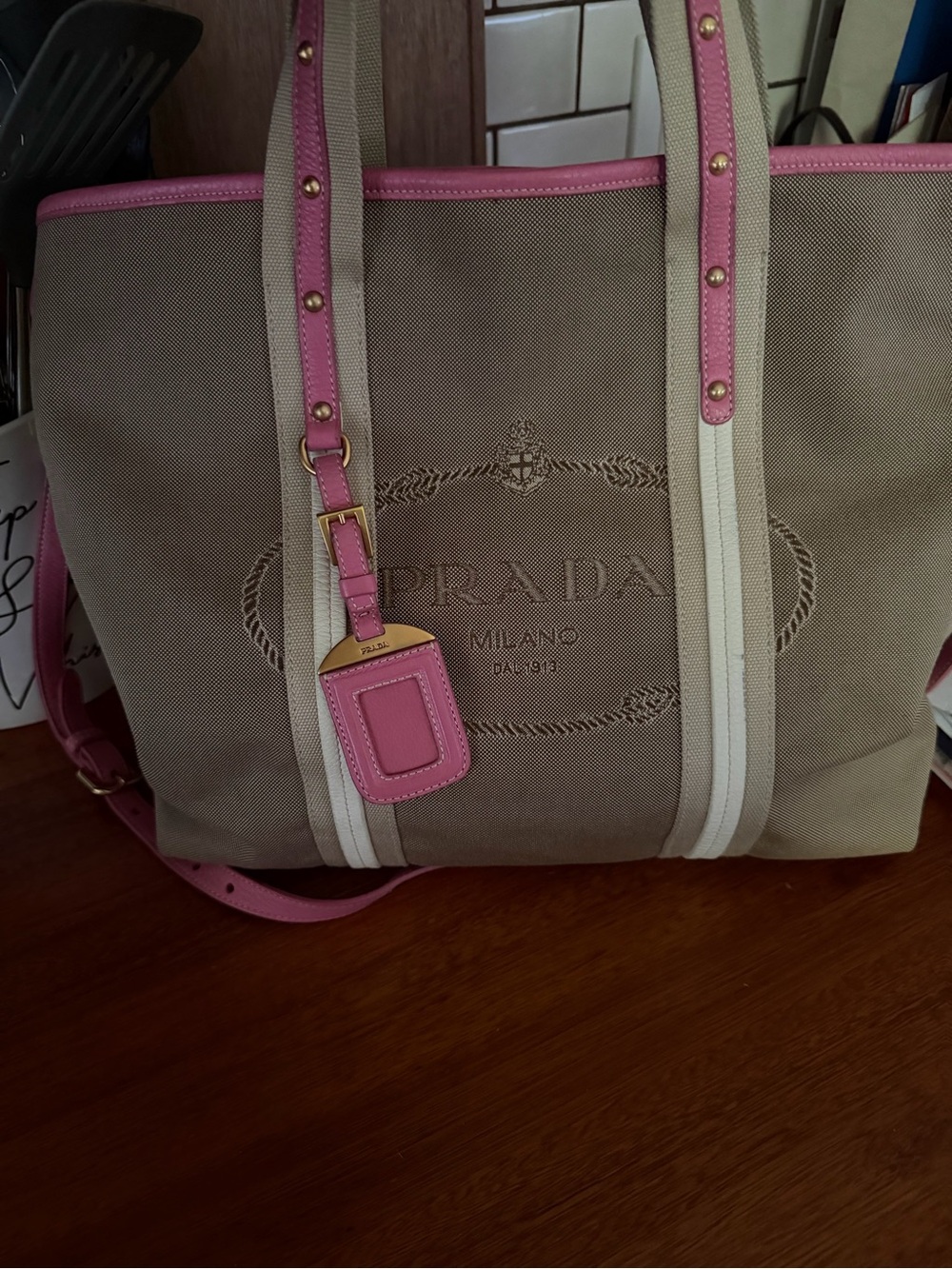 Prada Milano Beige Canvas Tote with Pink Trim and brass stud detail.